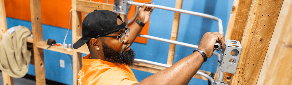Summit College electrician student working on wiring